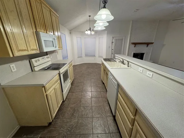 a hallway with a sink and dishwasher