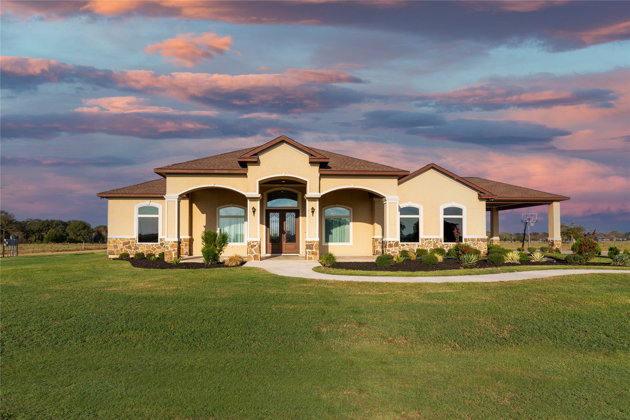 a front view of multiple houses with yard