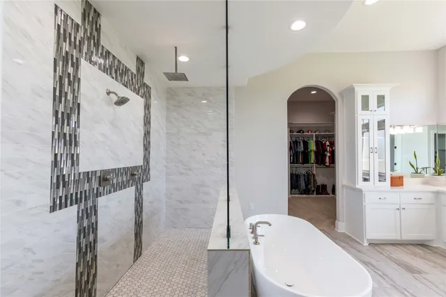 a view of walk in closet with clothes