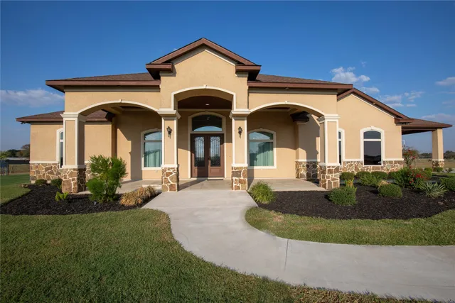 a front view of a house with a yard