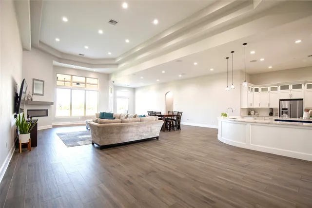 a large kitchen with kitchen island a large counter top space a sink stainless steel appliances and cabinets