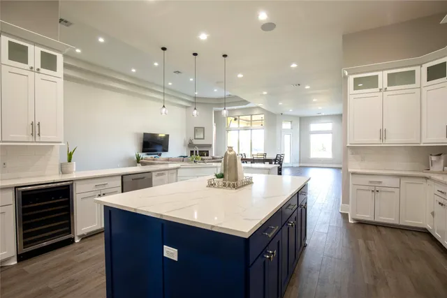 a kitchen with a sink window and cabinets