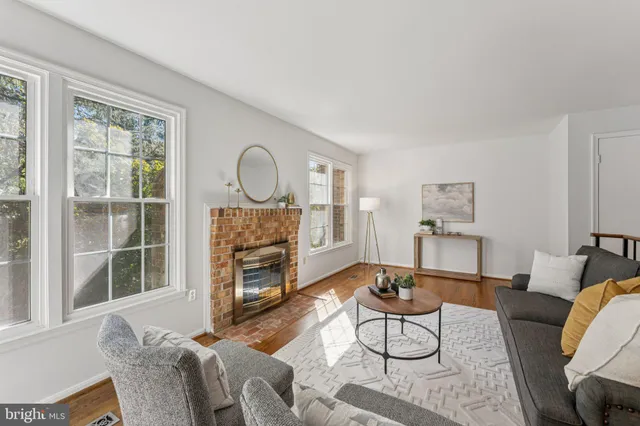 a view of a dining room with furniture and potted plant
