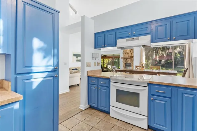 a kitchen with stainless steel appliances granite countertop a sink and a microwave oven on granite countertops