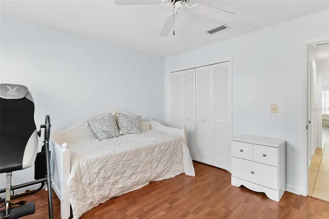 a view of a house with a yard patio and tree