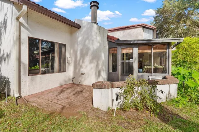 a view of a house with a yard and sitting area