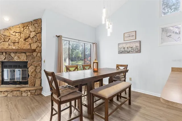 a white refrigerator freezer sitting inside of a kitchen with stainless steel appliances granite countertop wooden cabinets and sink