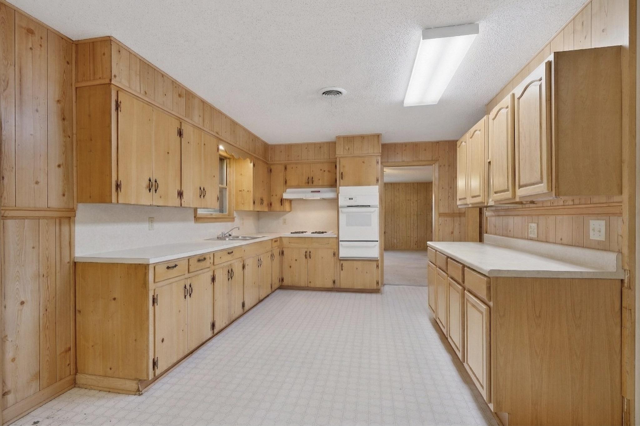 6808 Daugherty Street Austin, TX 78757 - Photo 12 of 20 a kitchen with stainless steel appliances a stove a sink and a refrigerator