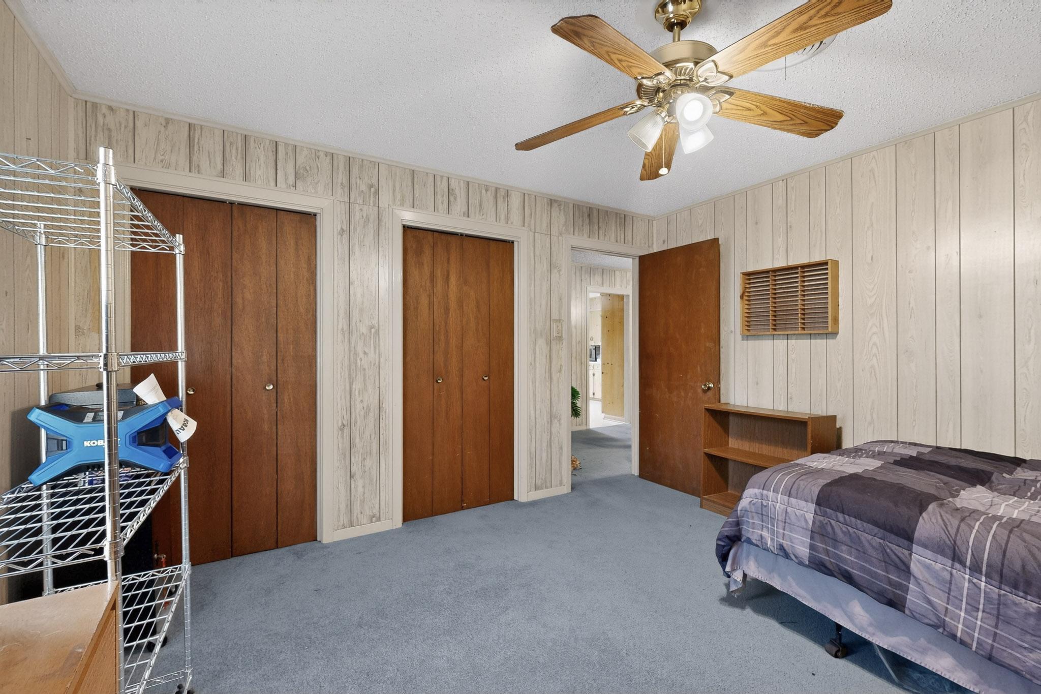 6808 Daugherty Street Austin, TX 78757 - Photo 13 of 20 a bedroom with a bed and a chandelier