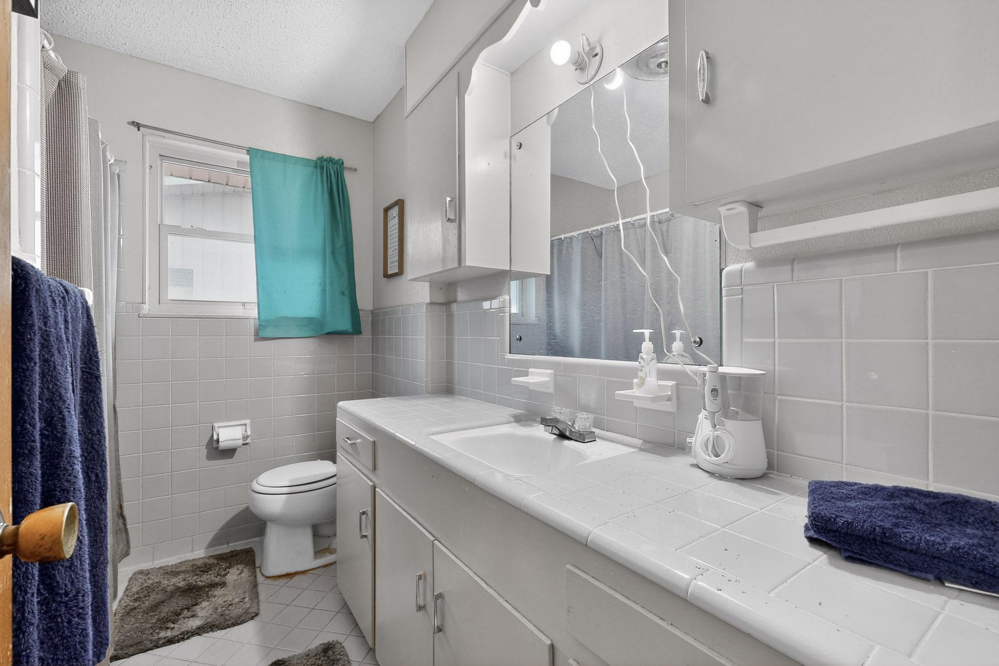 6808 Daugherty Street Austin, TX 78757 - Photo 14 of 20 a bathroom with a sink and a mirror