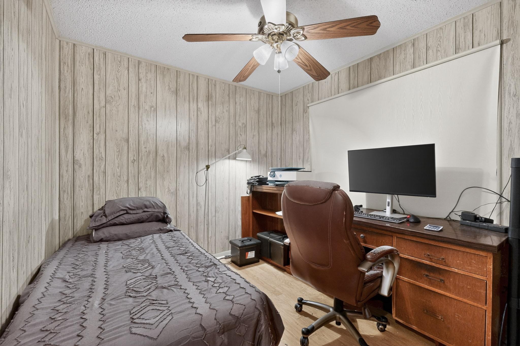 6808 Daugherty Street Austin, TX 78757 - Photo 15 of 20 a bedroom with a bed and a flat screen tv