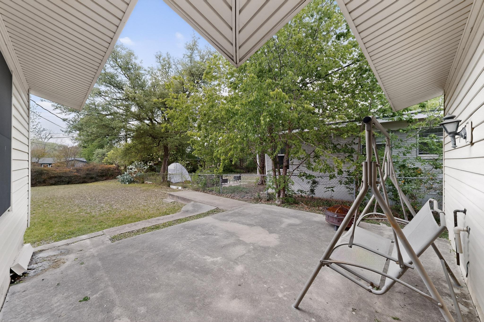 6808 Daugherty Street Austin, TX 78757 - Photo 18 of 20 a backyard of a house with table and chairs