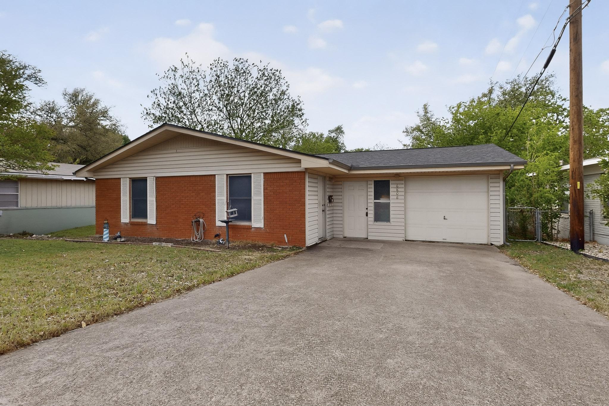 6808 Daugherty Street Austin, TX 78757 - Photo 2 of 20 a view of a house with a yard and large tree