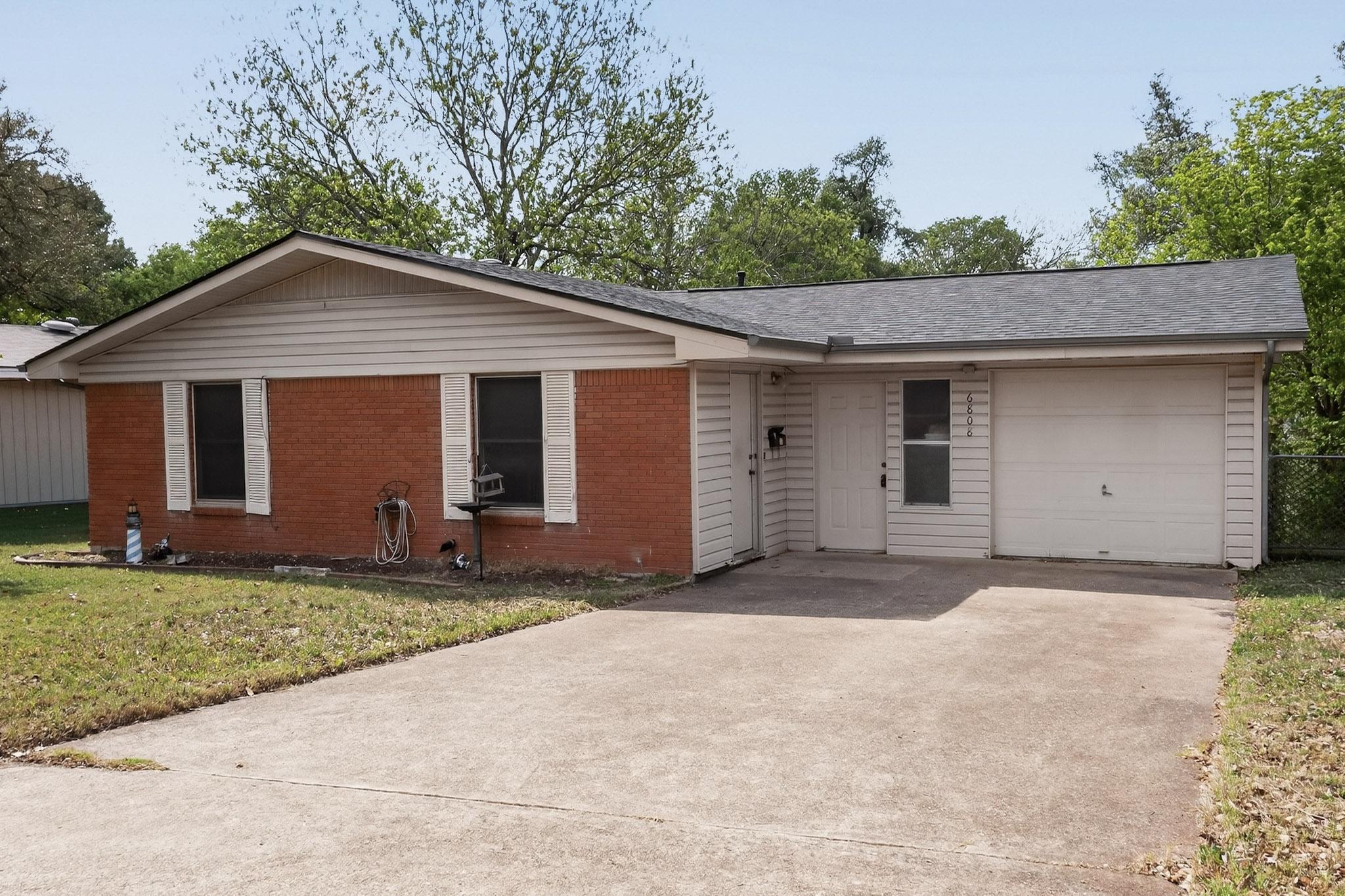 6808 Daugherty Street Austin, TX 78757 - Photo 6 of 20 a front view of a house with a yard and garage