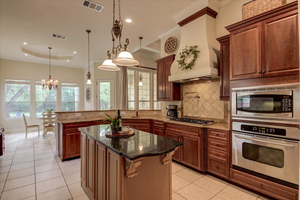 a kitchen with a sink stove and cabinets