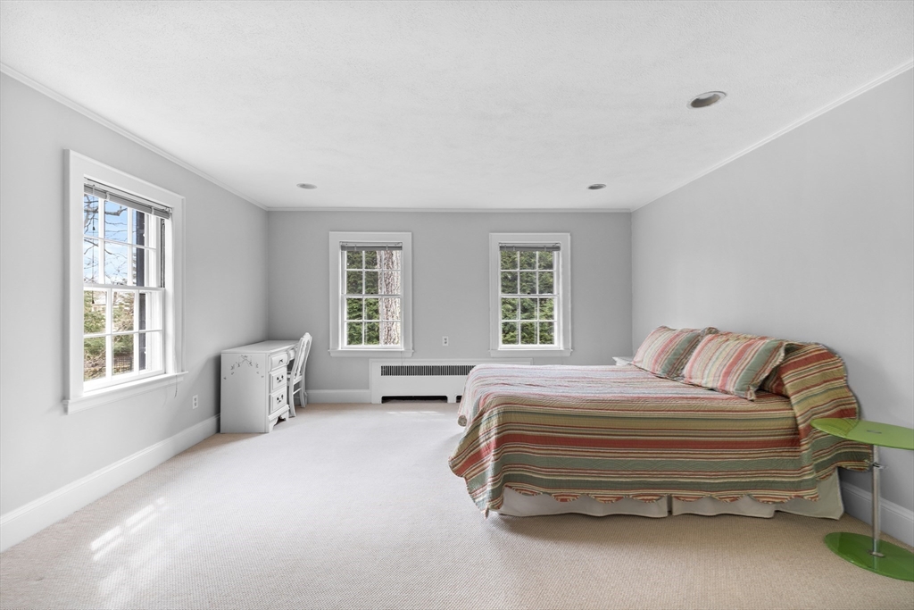 29 Woodcliff Road Wellesley, MA 02481 - Photo 18 of 31 a bedroom with a bed and wooden floor