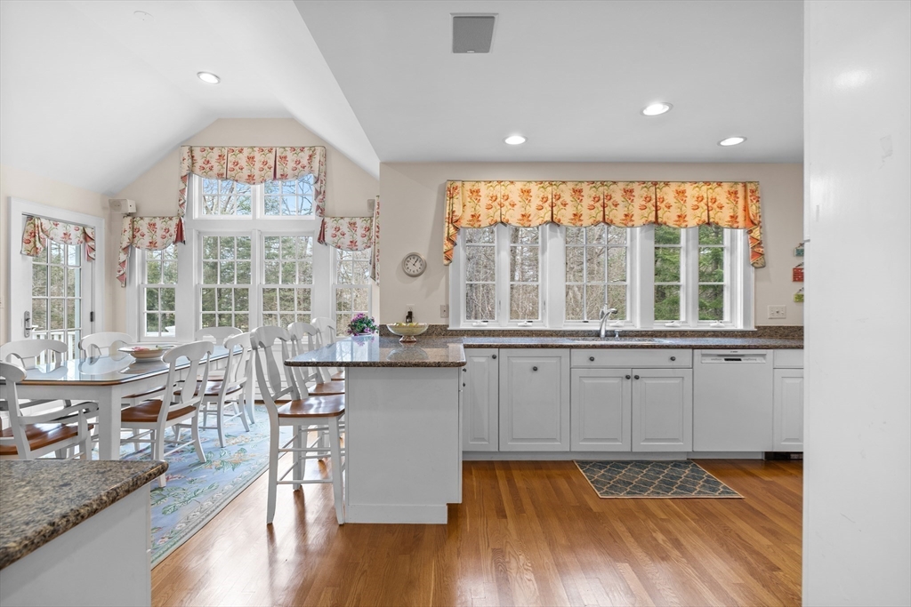 29 Woodcliff Road Wellesley, MA 02481 - Photo 6 of 31 a open kitchen with granite countertop a stove and white cabinets with wooden floor