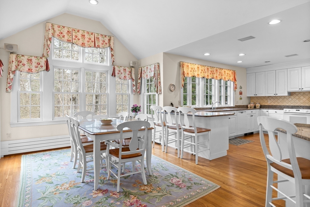 29 Woodcliff Road Wellesley, MA 02481 - Photo 7 of 31 a kitchen with stainless steel appliances granite countertop a table and chairs in it