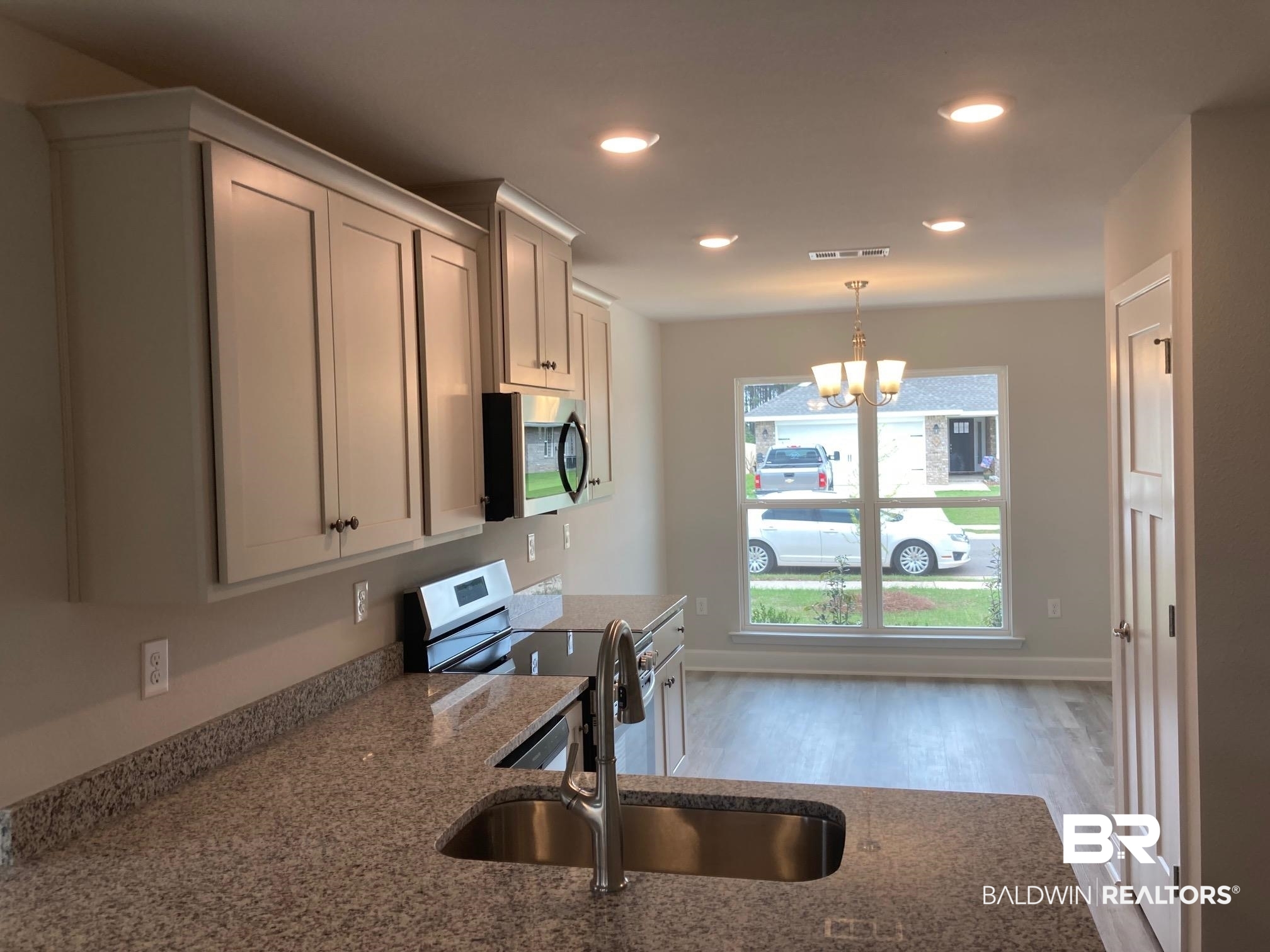 649 Revere Street Foley, AL 36535 - Photo 5 of 18 Kitchen featuring visible vents, stainless steel appliances, recessed lighting, a sink, and light stone counters