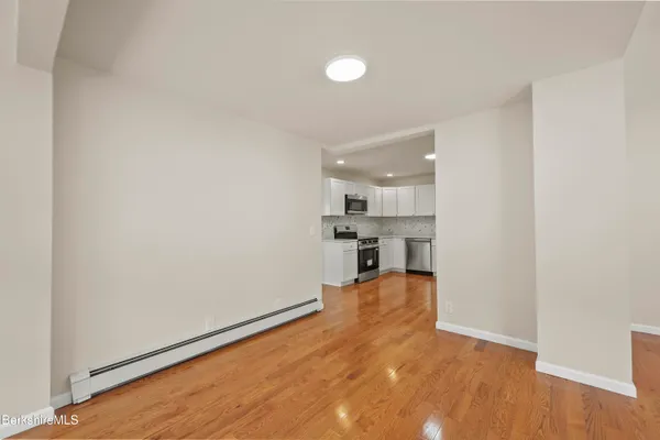 a view of a kitchen with wooden floor