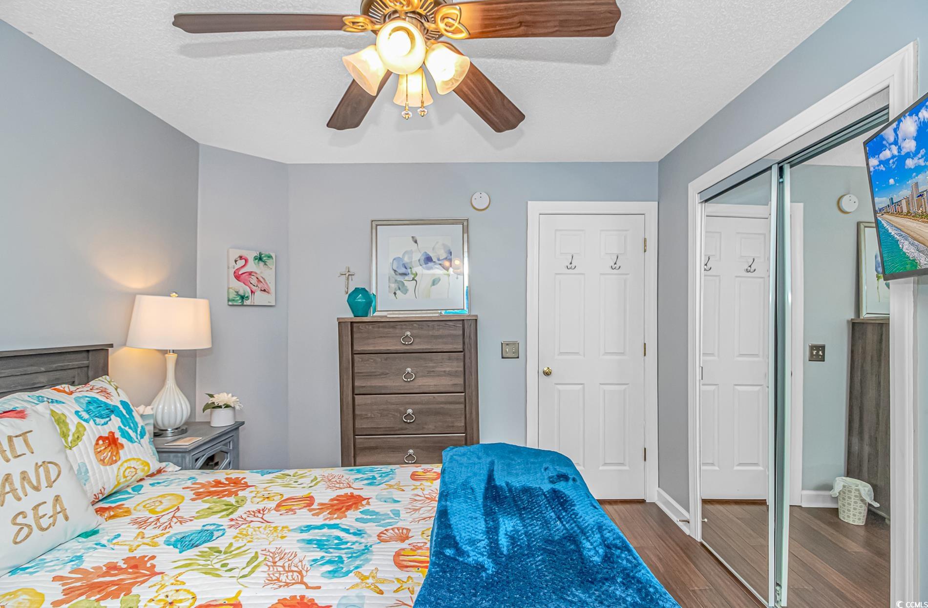 4394 Daphne Lane, Unit G Murrells Inlet, SC 29576 - Photo 20 of 30 Bedroom featuring a textured ceiling, wood finished floors, a closet, and ceiling fan
