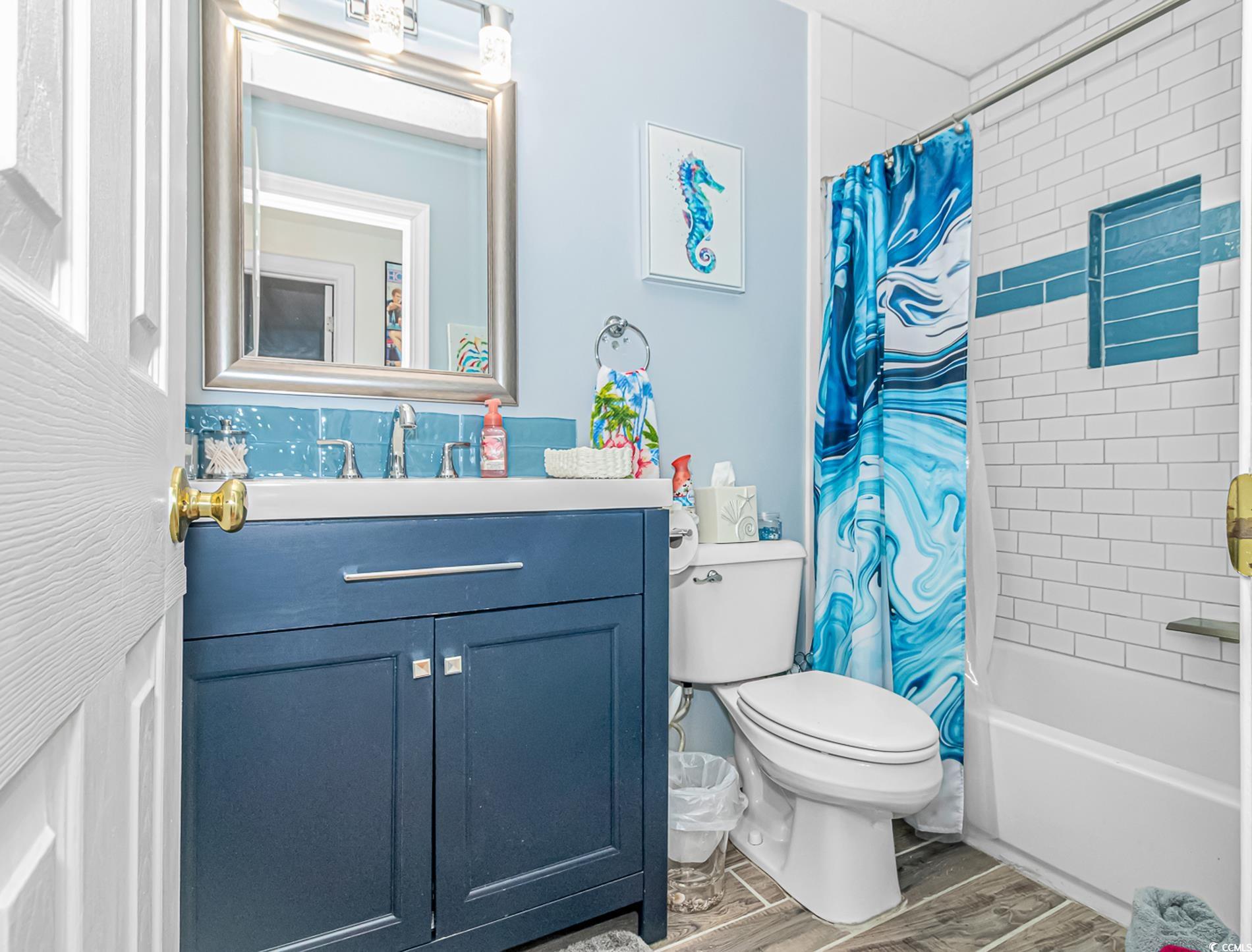 4394 Daphne Lane, Unit G Murrells Inlet, SC 29576 - Photo 21 of 30 Full bath featuring vanity, shower / bath combination with curtain, and light wood-style flooring