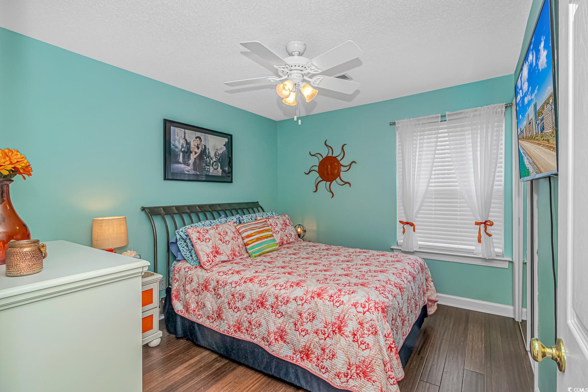 4394 Daphne Lane, Unit G Murrells Inlet, SC 29576 - Photo 22 of 30 Bedroom featuring dark wood finished floors, a textured ceiling, and ceiling fan