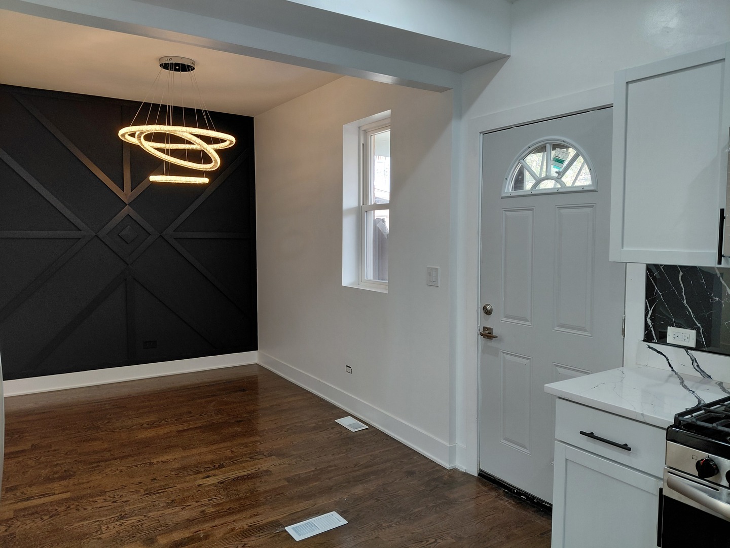 6441 South Campbell Avenue Chicago, IL 60629 - Photo 12 of 24 a view of an empty room with wooden floor and a window
