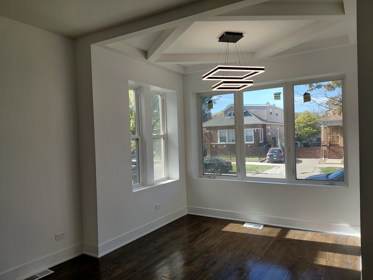 6441 South Campbell Avenue Chicago, IL 60629 - Photo 5 of 24 an empty room with wooden floor and windows