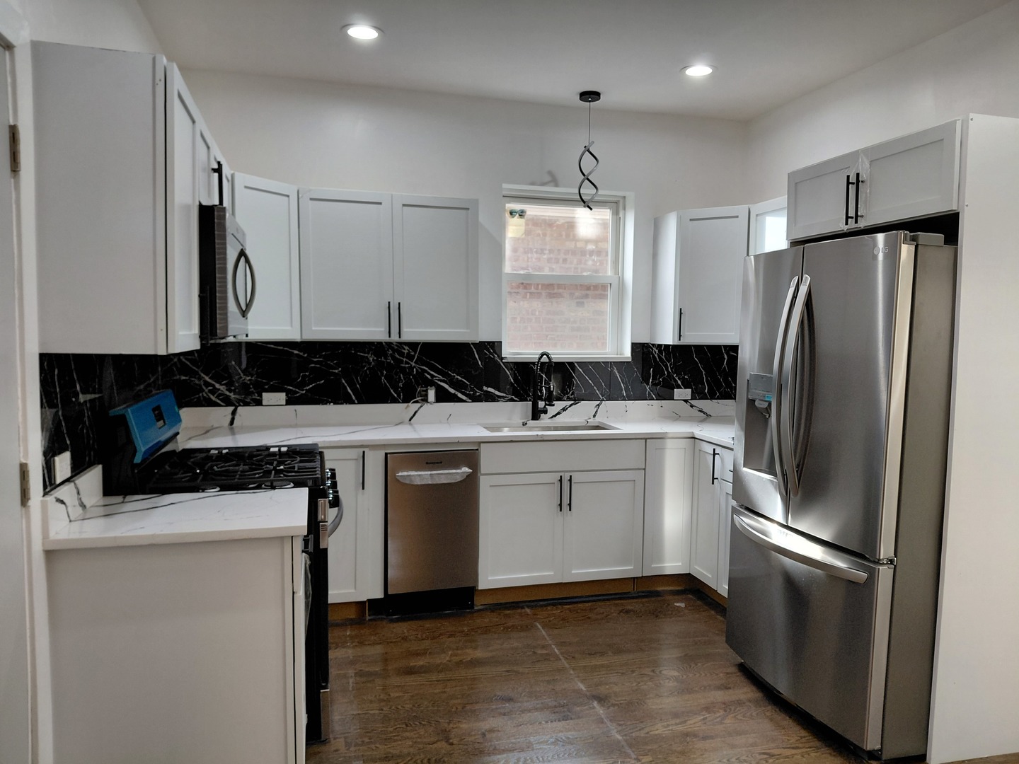 6441 South Campbell Avenue Chicago, IL 60629 - Photo 8 of 24 a kitchen with a refrigerator sink and cabinets