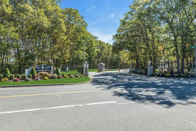 a side view of a house with a yard and pathway