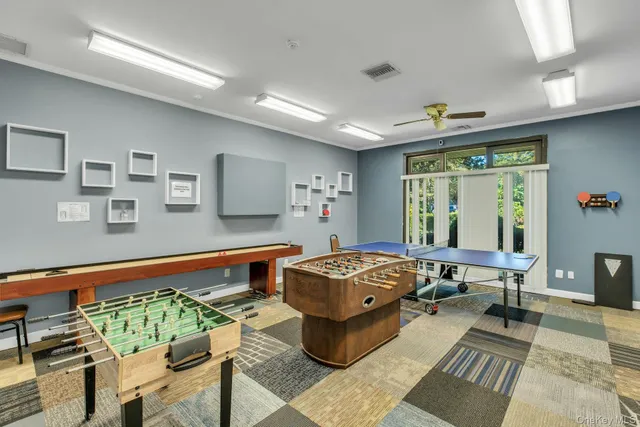 a room with pool tables and windows