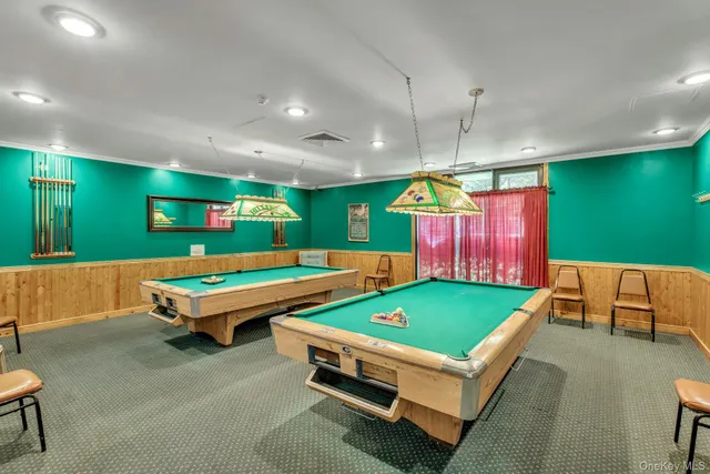 a living room with furniture large window and gym equipment