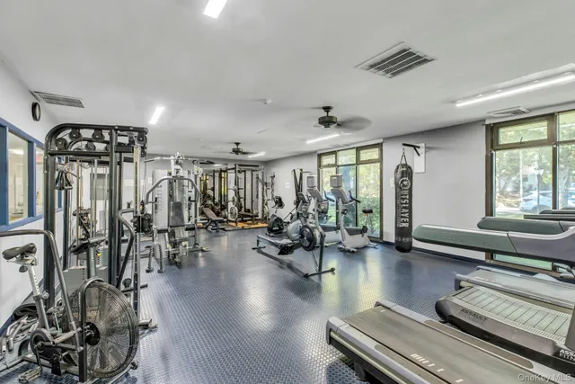 a dining room with furniture and a large window