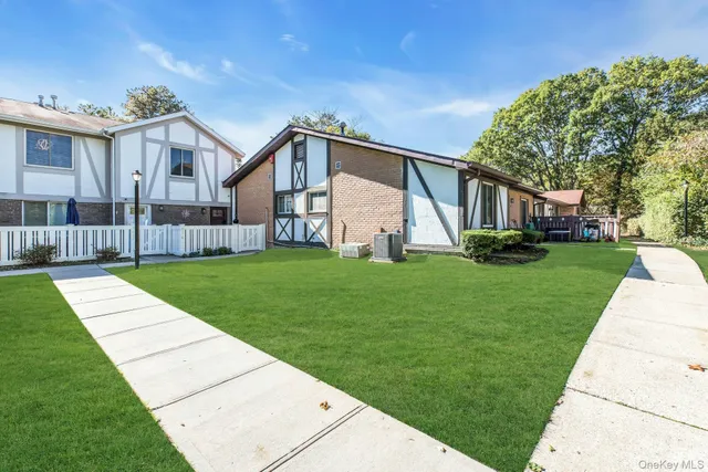 a front view of house with a yard and potted plants