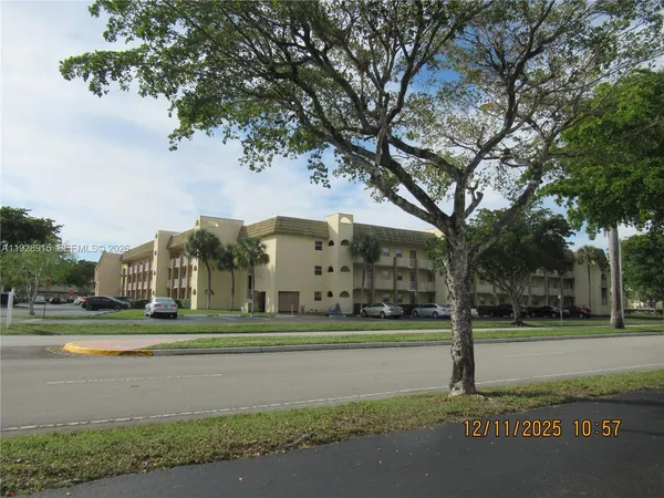 a front view of a building with a yard