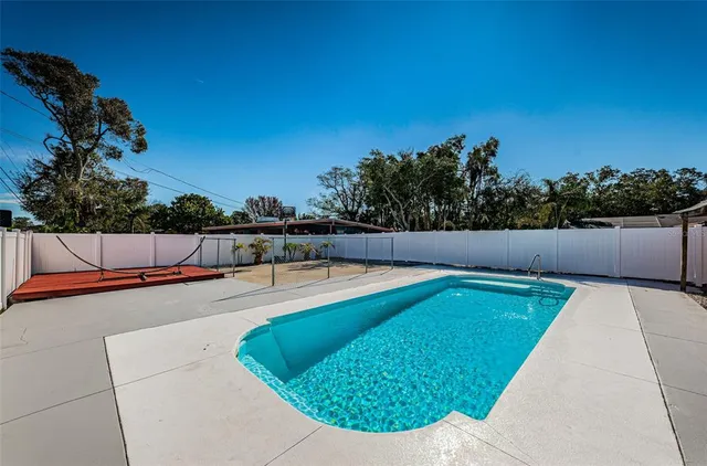 a view of a backyard with swimming pool