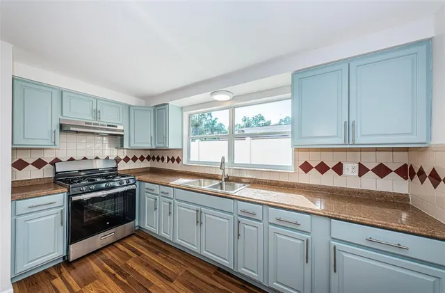 a kitchen with stainless steel appliances granite countertop a stove and a refrigerator