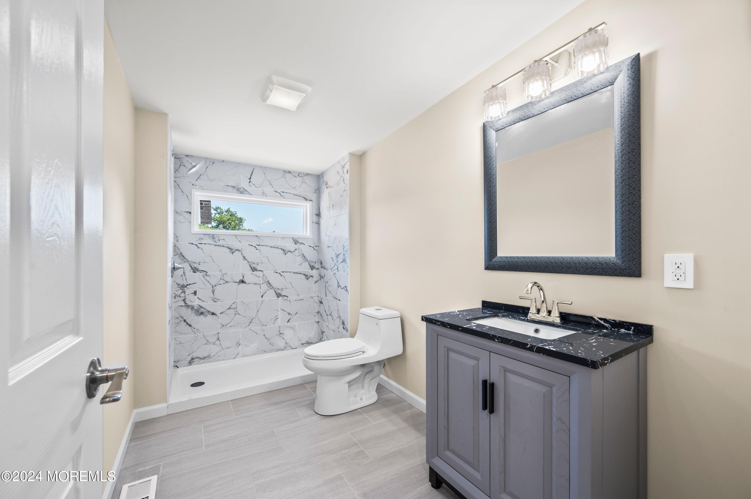 124 Victoria Place Union Beach, NJ 07735 - Photo 12 of 29 a bathroom with a granite countertop sink toilet and mirror