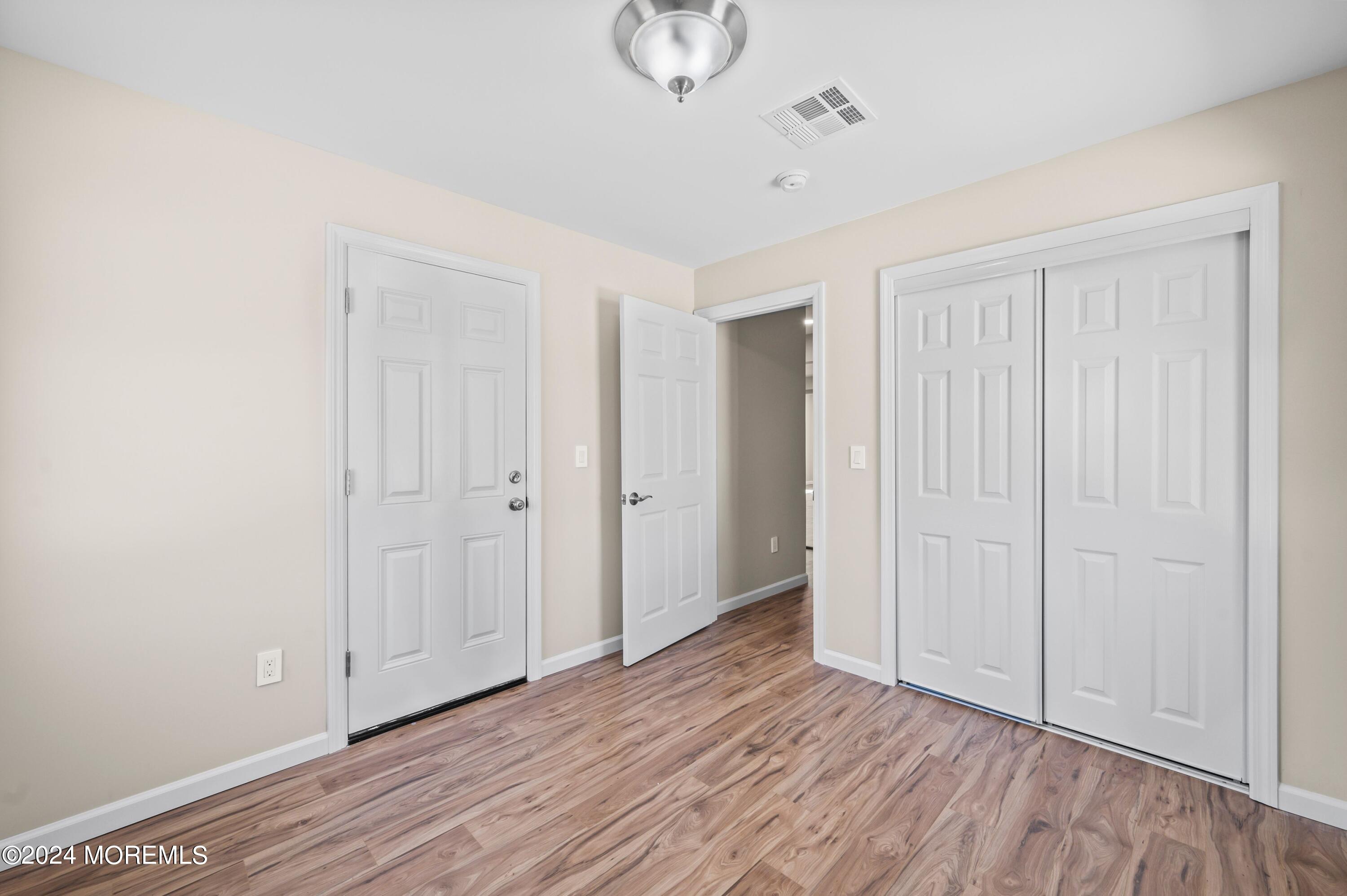 124 Victoria Place Union Beach, NJ 07735 - Photo 13 of 29 a view of an empty room with wooden floor