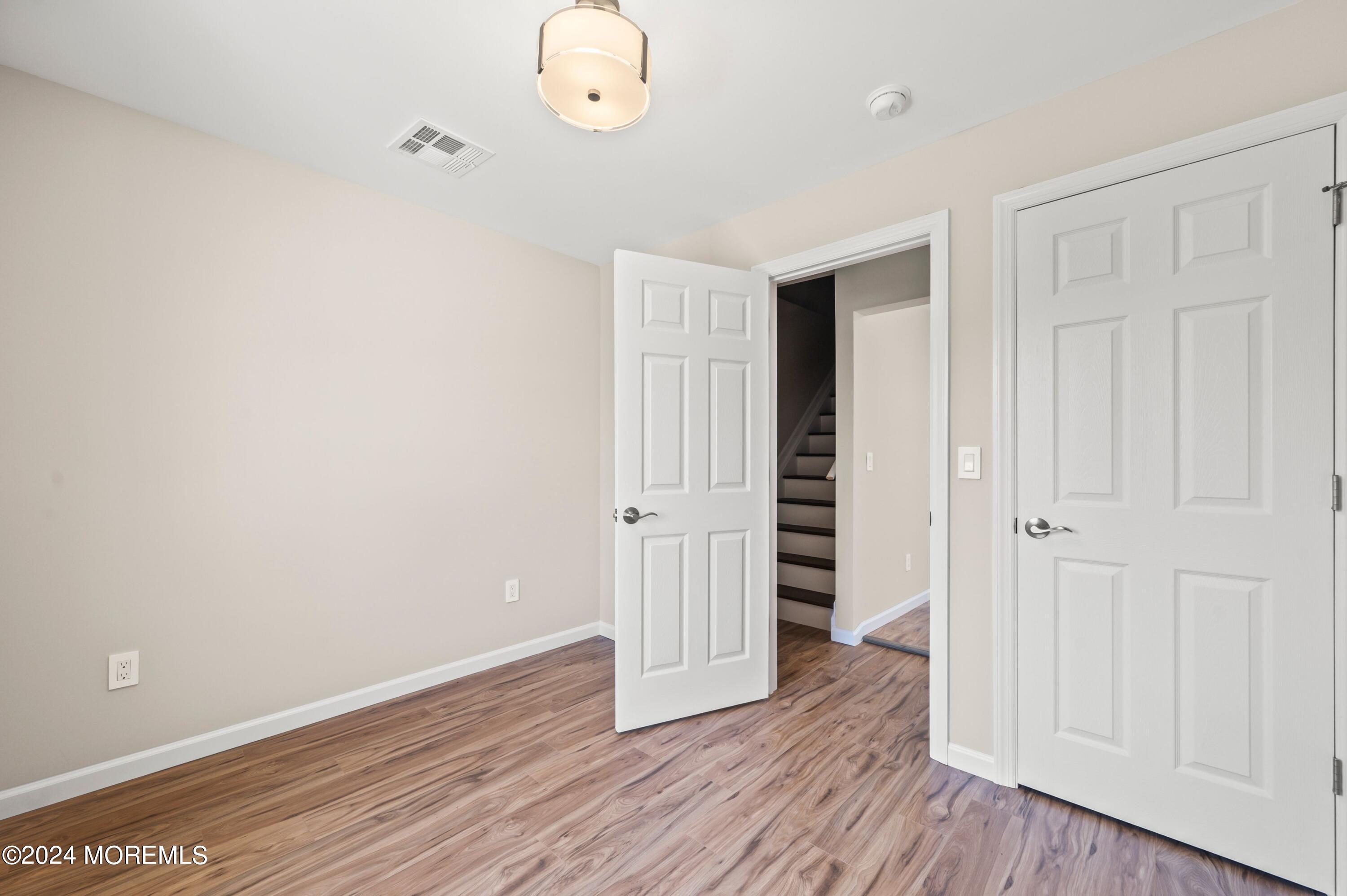 124 Victoria Place Union Beach, NJ 07735 - Photo 15 of 29 an empty room with wooden floor and closet