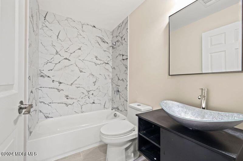 124 Victoria Place Union Beach, NJ 07735 - Photo 18 of 29 a bathroom with a granite countertop toilet sink and mirror