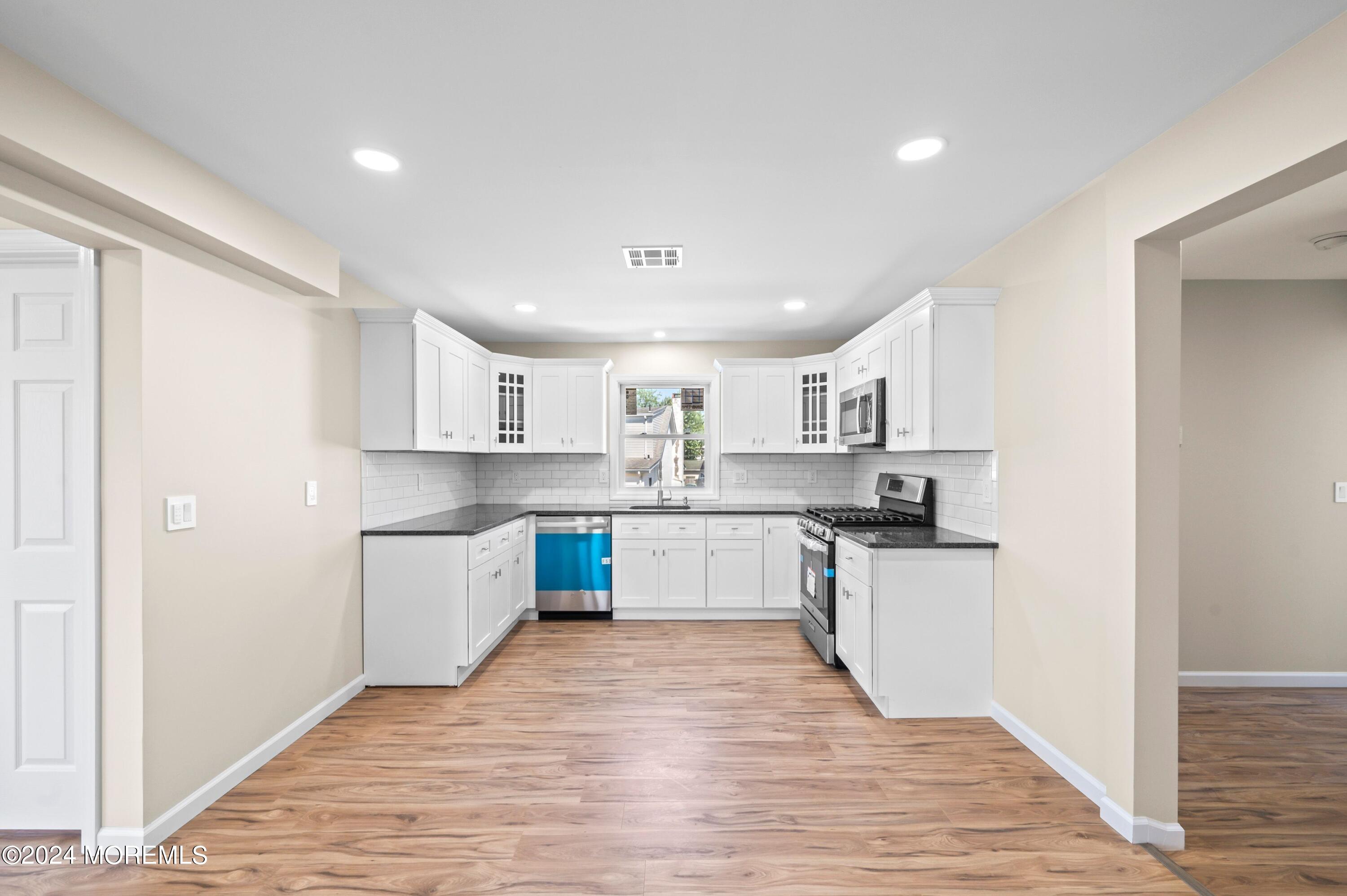 124 Victoria Place Union Beach, NJ 07735 - Photo 6 of 29 a kitchen with white cabinets appliances and sink