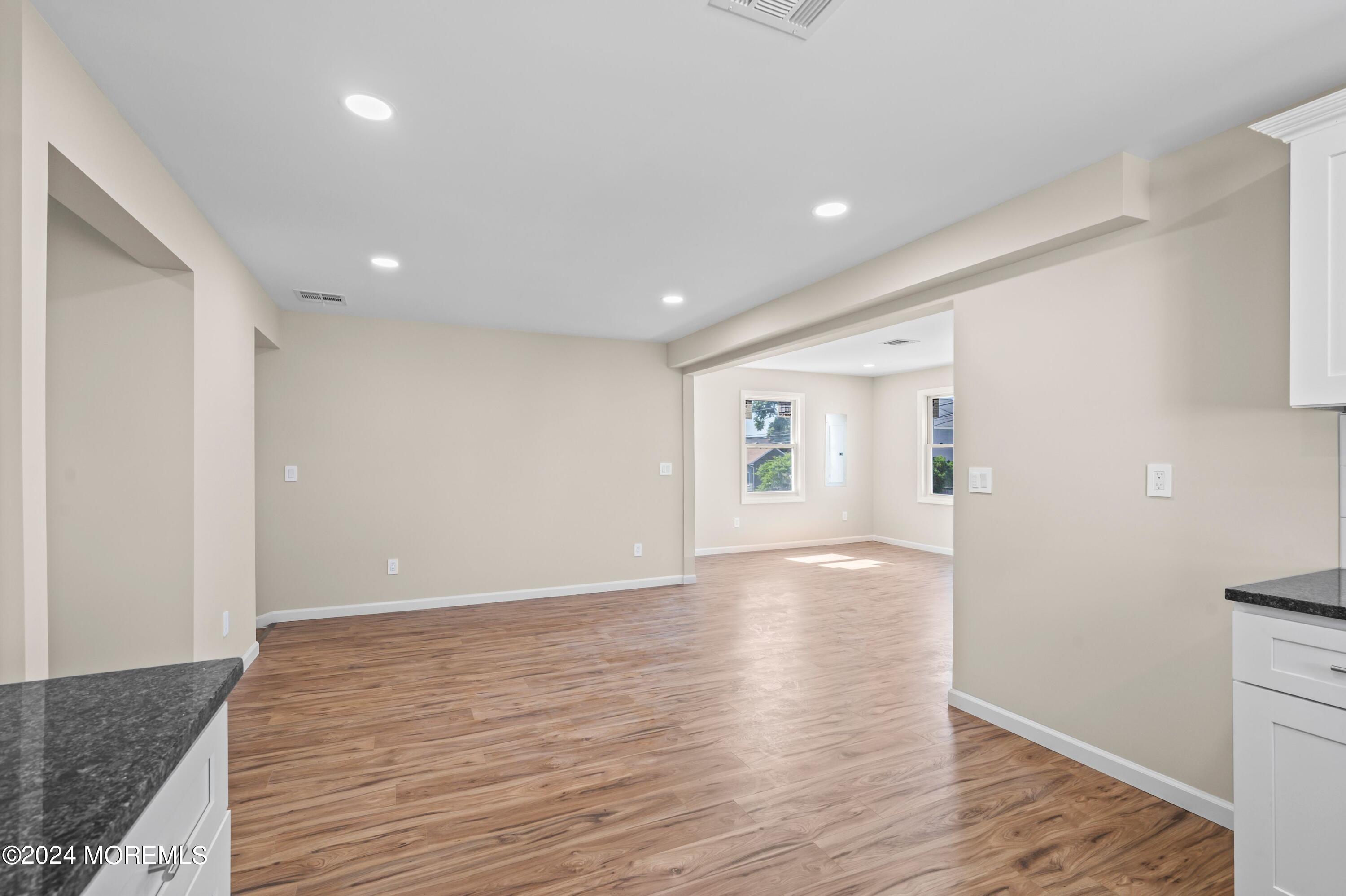 124 Victoria Place Union Beach, NJ 07735 - Photo 7 of 29 a view of an empty room with wooden floor and a window