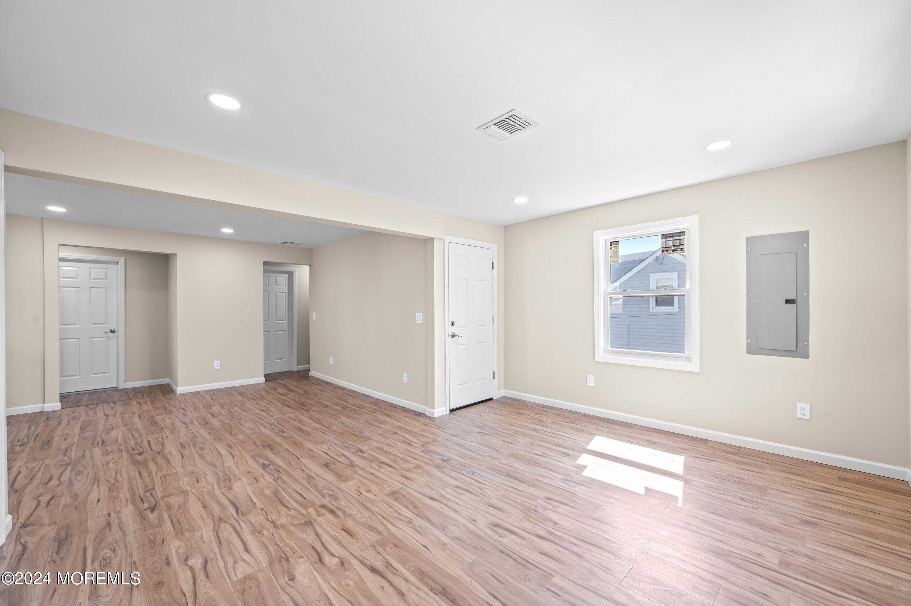 124 Victoria Place Union Beach, NJ 07735 - Photo 8 of 29 a view of an empty room with wooden floor and a window