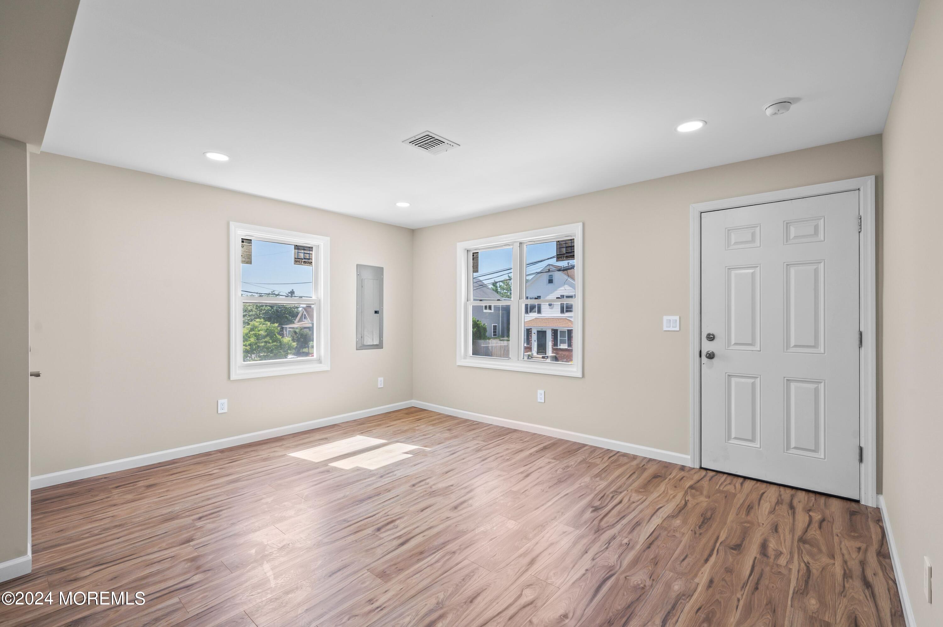 124 Victoria Place Union Beach, NJ 07735 - Photo 9 of 29 wooden floor in an empty room with a window