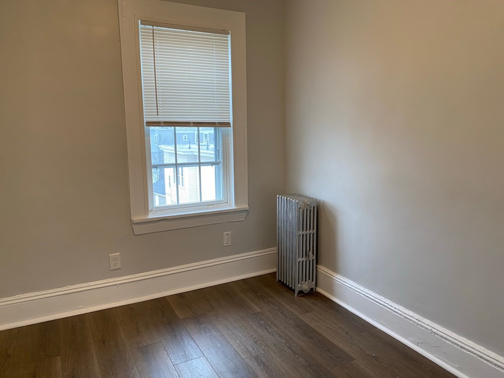 200 Congress Avenue, Unit 3 Chelsea, MA 02150 - Photo 11 of 14 an empty room with wooden floor and windows