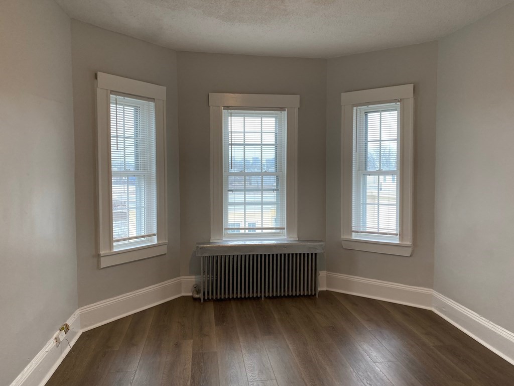 200 Congress Avenue, Unit 3 Chelsea, MA 02150 - Photo 13 of 14 a view of an empty room with wooden floor and a window