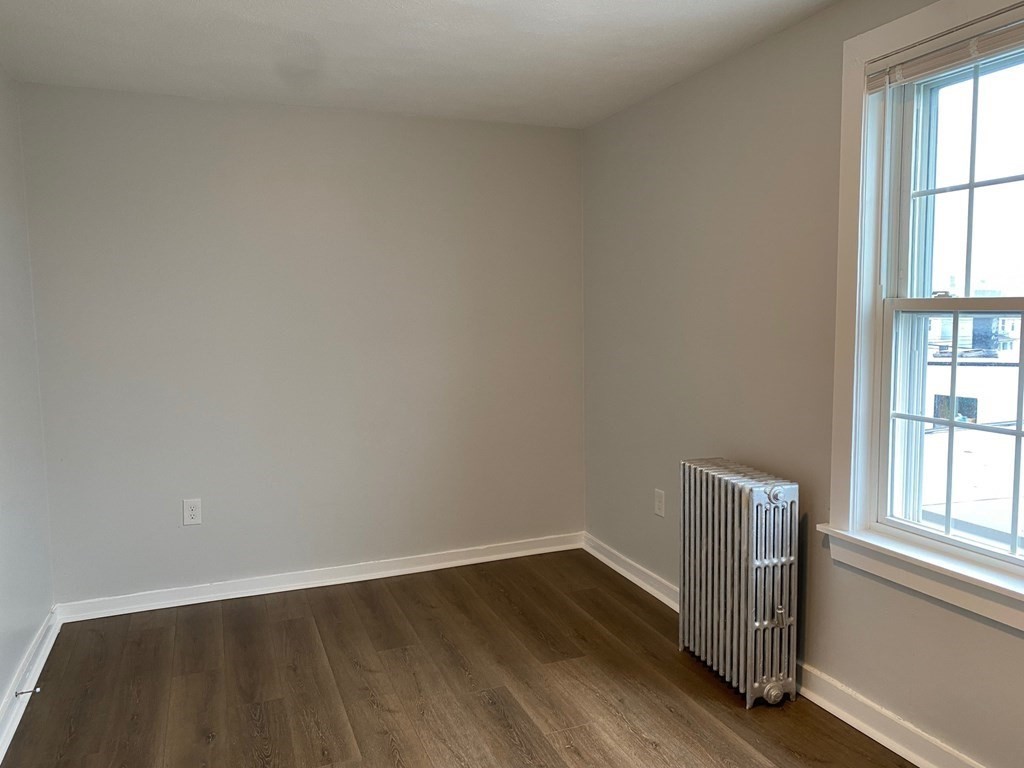 200 Congress Avenue, Unit 3 Chelsea, MA 02150 - Photo 4 of 14 a view of an empty room with wooden floor and a window