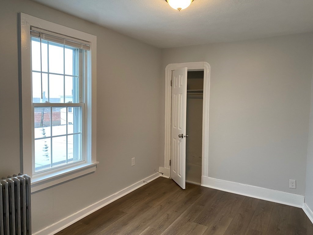200 Congress Avenue, Unit 3 Chelsea, MA 02150 - Photo 5 of 14 an empty room with wooden floor and windows